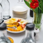 An elegant dining setup featuring fresh fruits and vibrant tulips, perfect for a healthy meal.
